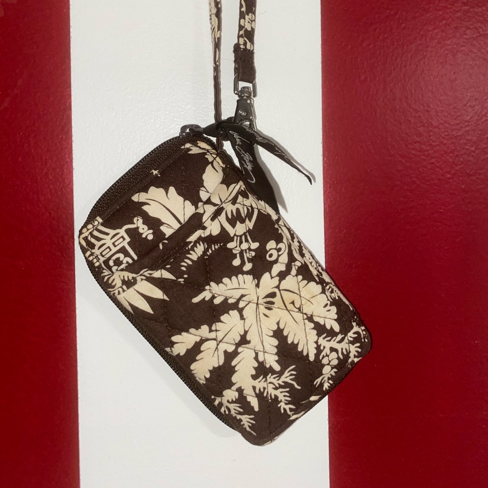 A Vera Bradley wristlet WITH stains pictured